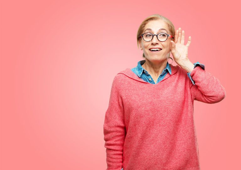 Happy woman trying to hear and listen to what is being said